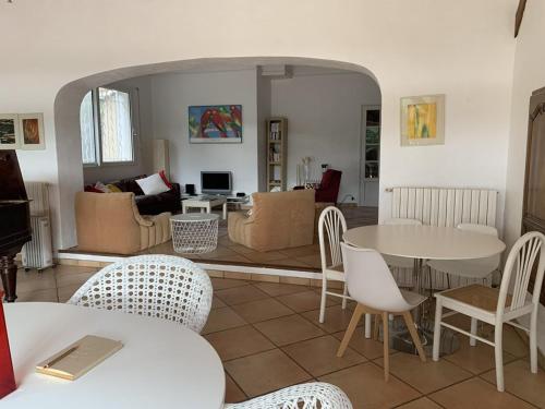 un salon avec une table et des chaises dans l'établissement Villa à Hyères avec piscine, climatisation et Wi-Fi, à 5 min de la plage - FR-1-335-169, à Hyères