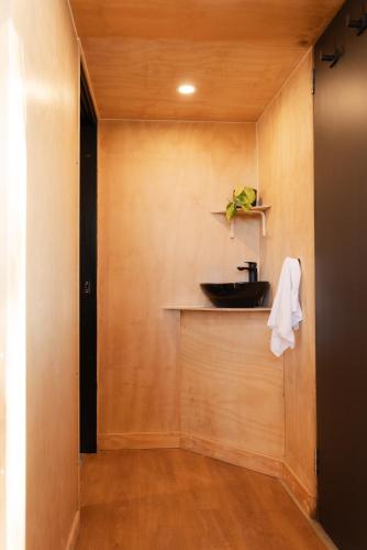 a bathroom with a sink on a wall at CABN McLaren Vale in McLaren Flat