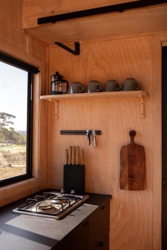 a kitchen with a stove top in a tiny house at CABN McLaren Vale in McLaren Flat