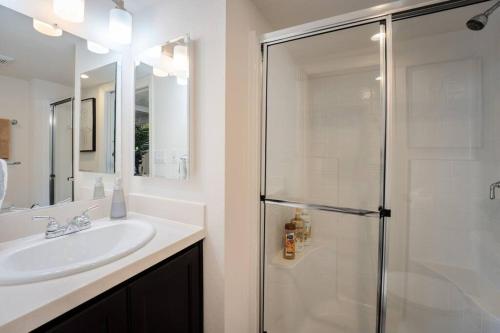 a bathroom with a sink and a glass shower at Coastal Tiny House 2 Queen Beds low loft in San Luis Obispo