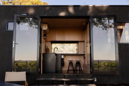 a kitchen with large glass windows and a counter at CABN McLaren Vale in McLaren Flat