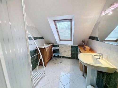 a small bathroom with a sink and a shower at Maison proche plage, 8 pers, 3 ch, jardin, Wi-Fi, clim - FR-1-361-533 in Saint-Pair-sur-Mer