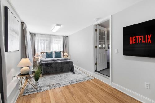 a bedroom with a bed and a tv on a wall at New Beach Home near Stamford Downtown/Shippan in Stamford