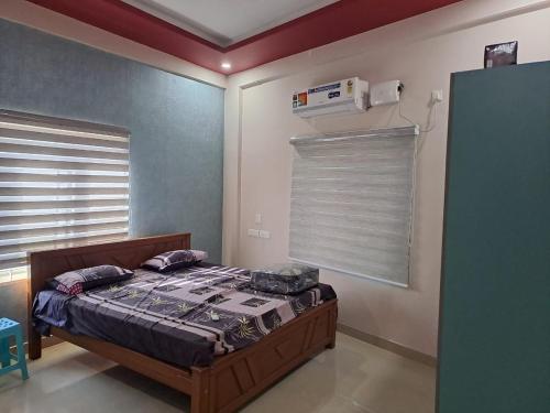 1 dormitorio con 1 cama en una habitación con ventana en Galeela Plaza, en Tāmarakulam