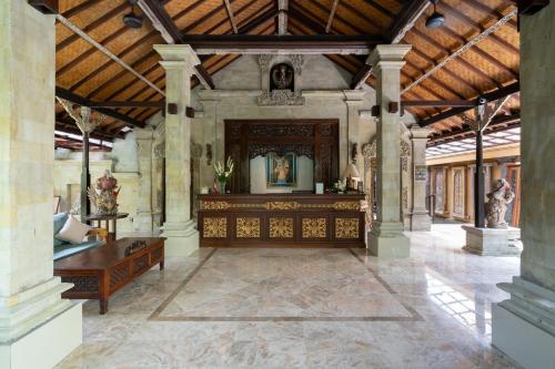 a large room with a wooden altar in a building at Svarga Bebek Villas in Ubud
