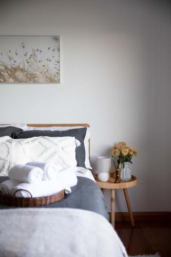 a bedroom with a bed with towels on a table at Sea View Guest House in Hobart