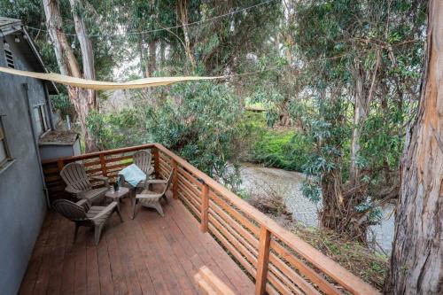 a deck with two chairs and a table on it at Peaceful Tiny Home Loft and Sauna in San Luis Obispo