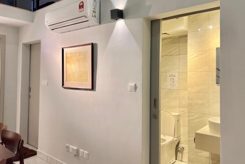 a bathroom with a toilet and a glass shower at Entire Loft Hosted by Forave Home Wi-Fi 500mbps in Kuala Lumpur