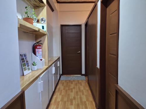 a hallway with wood floors and a door at Haven Haus with Mountain View in Baguio
