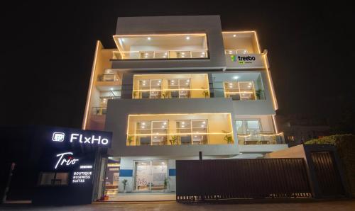 a tall building at night with its lights on at Treebo Trend FlxHo Trio - Medanta Medicity Gurgaon in Gurgaon