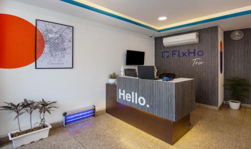 an office with a reception desk with ahello sign on the wall at Treebo Trend FlxHo Trio - Medanta Medicity Gurgaon in Gurgaon