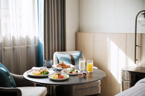 a hotel room with two plates of food on a table at Courtyard by Marriott Tokyo Ginza Hotel in Tokyo