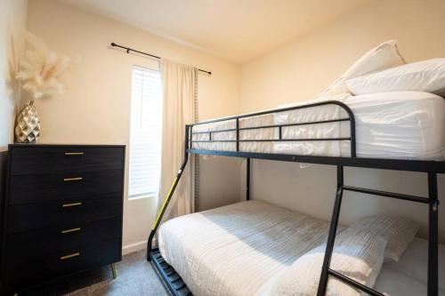 a bedroom with two bunk beds and a dresser at 2-Bedroom SLO Bungalow House in San Luis Obispo