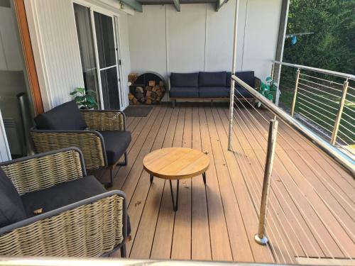 a porch with chairs and a table on a balcony at Hillview on Delany in Bright