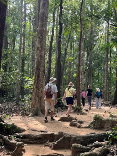 a group of people walking on a trail in the woods at Vajra Ayurveda and Yoga Retreat in Cochin