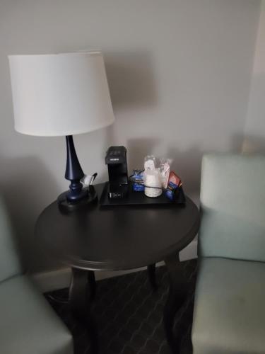 a table with a lamp and a telephone on it at Natural Bridge Hotel, Trademark Collection by Wyndham in Natural Bridge