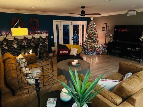 a living room with a christmas tree in the background at Huntington Beach, AC, Pool, Hot Tub, Detached Office, Close to Beach, Outside Entertaining Area in Huntington Beach