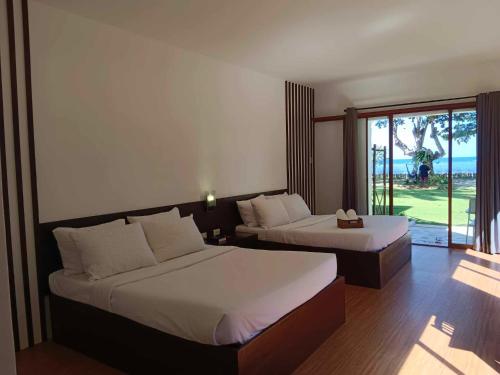 1 Schlafzimmer mit 2 Betten und Meerblick in der Unterkunft Ananyana Leisure Beach Resort in Panglao