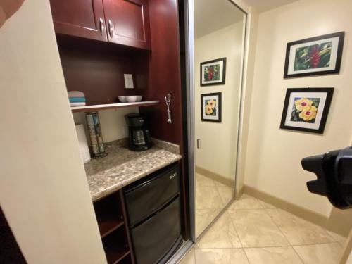 a small kitchen with a sink and a mirror at Hanalei Bay Resort 6101 condo in Princeville