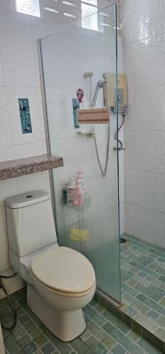 a bathroom with a toilet and a shower at Pakin house in Ban Nua Khlong