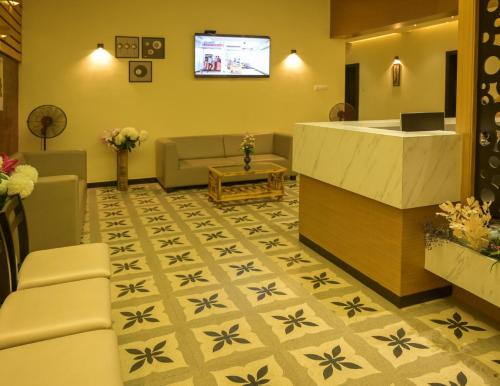 a lobby with a waiting room with a tv at Hotel Limelight in Kudal