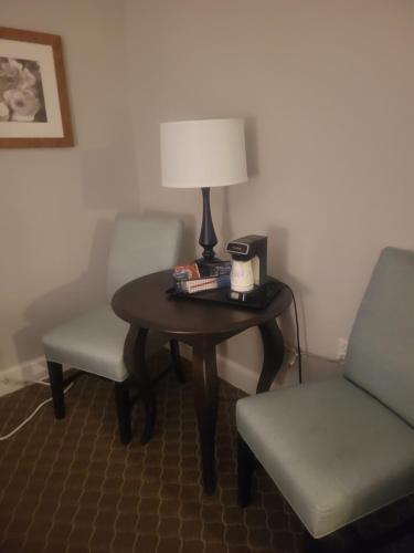 a table with a lamp and two chairs in a room at Natural Bridge Hotel, Trademark Collection by Wyndham in Natural Bridge