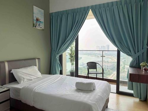 a bedroom with a bed and a large window at Royal Strand Country Garden Danga Bay in Johor Bahru