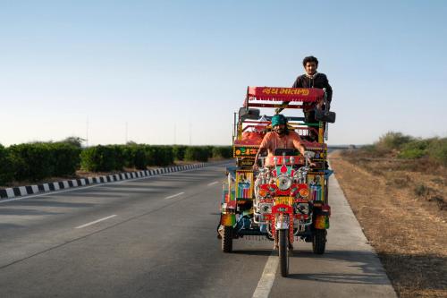 a man is riding a truck on a road at Hawthorn Suites by Wyndham Dwarka in Dwarka