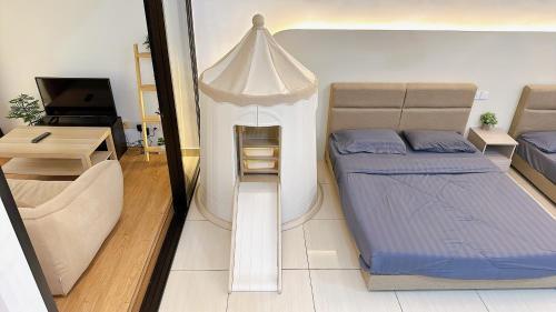 a small bedroom with a bed and a table at Mount Austin Manhanttan Sovo by Cactus Homestay in Johor Bahru