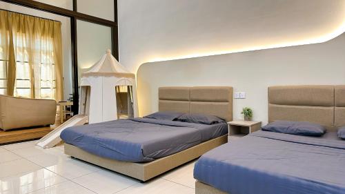 a bedroom with two beds and a large window at Mount Austin Manhanttan Sovo by Cactus Homestay in Johor Bahru