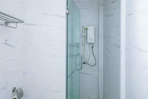 a shower with a glass door in a bathroom at Sea Breeze Resort in Sihanoukville