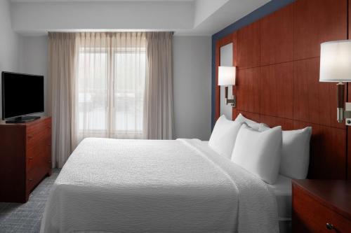 a hotel room with a bed and a television at Residence Inn East Rutherford Meadowlands in East Rutherford
