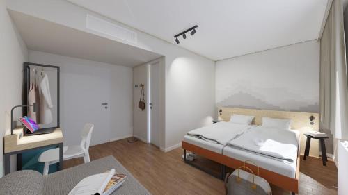 1 dormitorio con 1 cama y escritorio con ordenador en MEININGER Hotel München Zentrum en Múnich