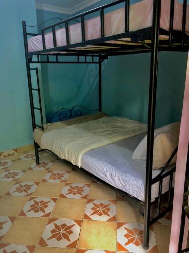 two bunk beds in a room with a tile floor at Tanzania Homestay in Arusha