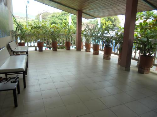 a large room with potted plants in a building at Hotel Joohn Gay only LGBTIQ in Melgar