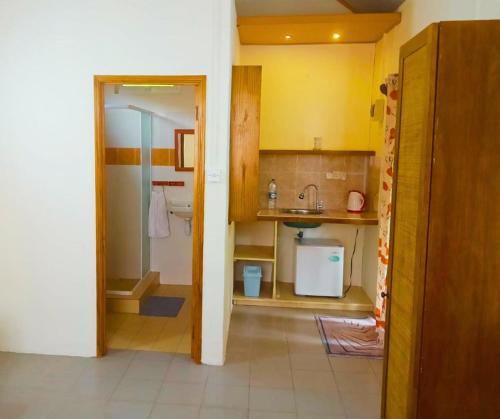 a small kitchen with a sink and a bathroom at Les Varangues Rodrigues in Rodrigues Island