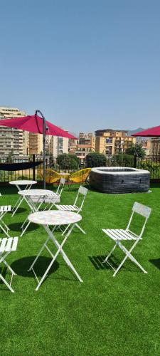a group of chairs and tables on the grass at I Sollazzi in Palermo
