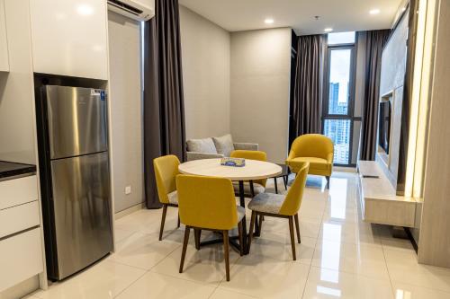 a kitchen and dining room with a table and chairs at Societe Suites By iHost Global in Kuala Lumpur