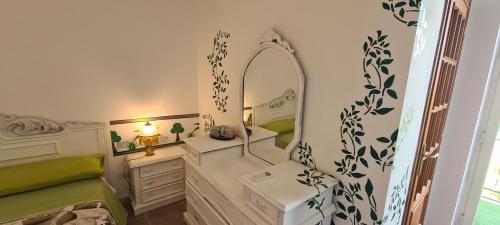a bathroom with a vanity with a mirror and a sink at I Sollazzi in Palermo