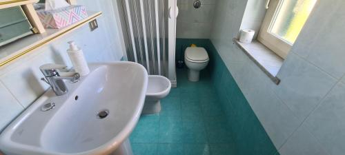 a bathroom with a white sink and a toilet at I Sollazzi in Palermo