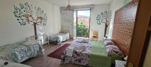 a room with two beds and a cross on the wall at I Sollazzi in Palermo