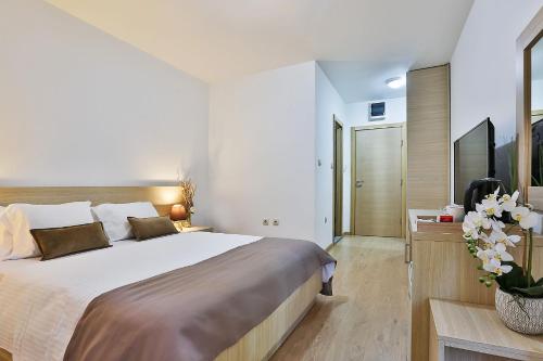 a bedroom with a large bed and a television at Villa Vanty in Sveti Stefan