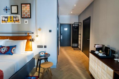 a hotel room with a bed and a small table at Hotel Indigo Belgrade by IHG in Belgrade