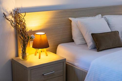 a bedroom with a bed and a lamp on a night stand at Villa Vanty in Sveti Stefan