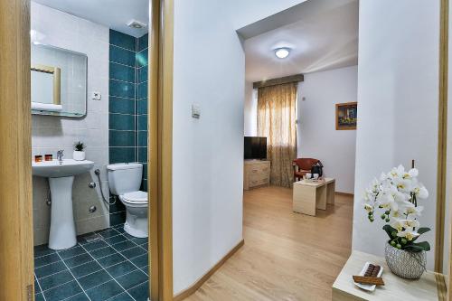 a bathroom with a toilet and a sink at Kolomat in Sveti Stefan