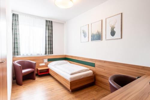 a hospital room with a bed and a desk at Leonfeldner-Hof in Bad Leonfelden