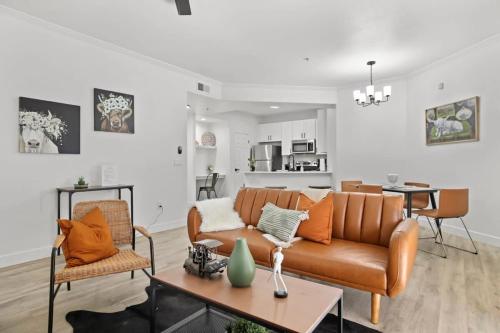 a living room with a couch and a table at Champion's CozySuite walk to the stadium with pool! in Glendale