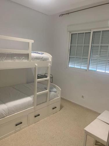 a room with a bunk bed and a window at vistas desde montequinto in Dos Hermanas
