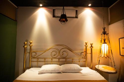 1 cama con sábanas blancas y almohadas en una habitación en Casa Maria Jimena Hotel Boutique, en Chihuahua