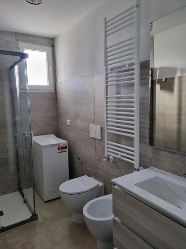 a bathroom with a toilet and a sink and a shower at La Corte di Rosa in San Vito al Tagliamento